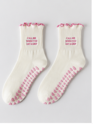 Cream Pilates socks showing pink grips on both soles