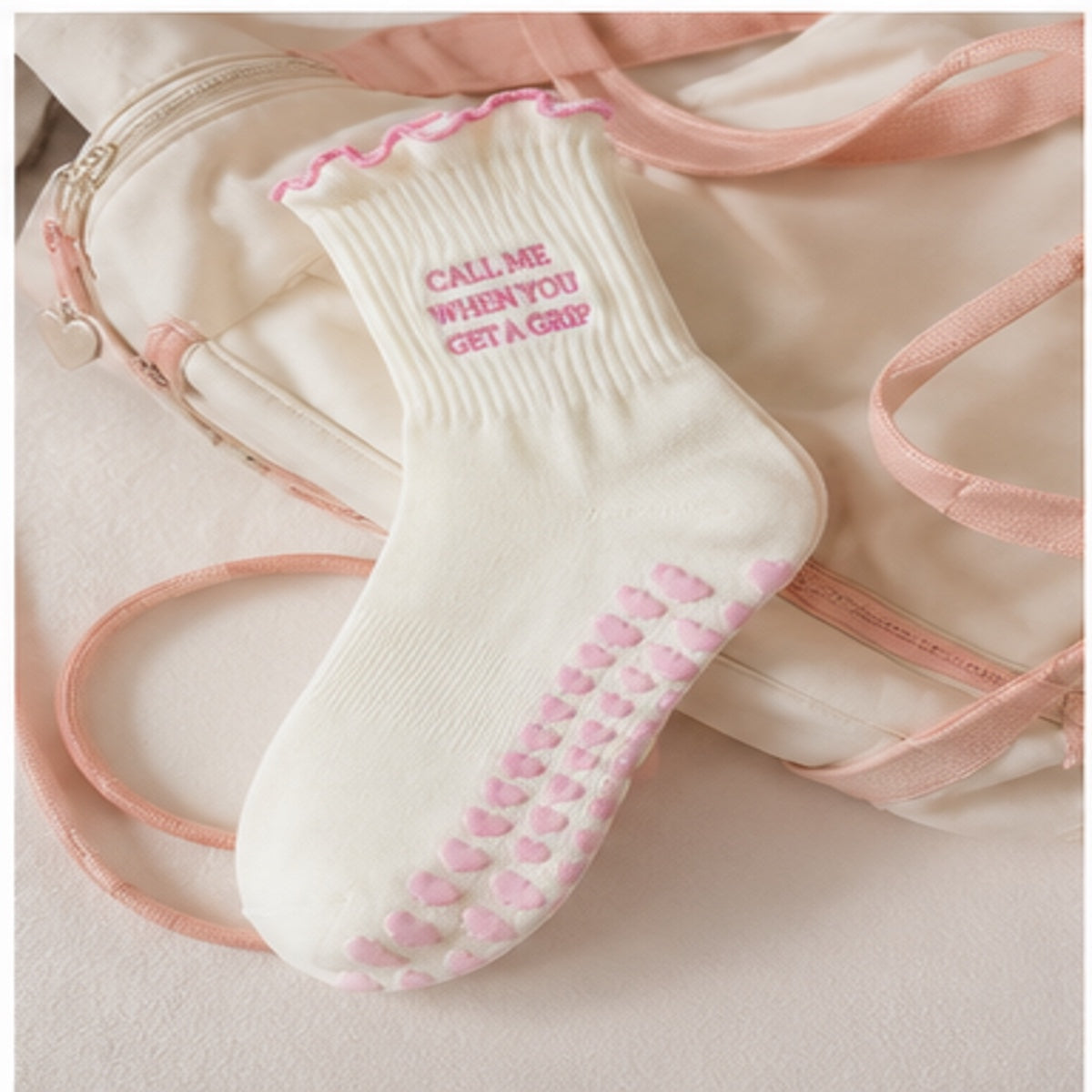 Cream and pink Pilates grip socks styled with ballet accessories