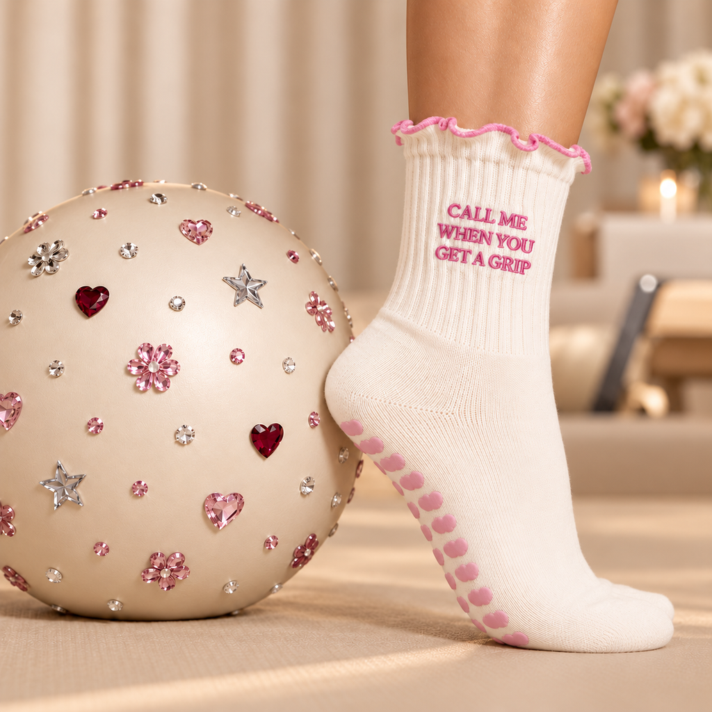 Lifestyle close-up of cream Pilates sock with cloud grips and pink trim
