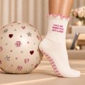 Lifestyle close-up of cream Pilates sock with cloud grips and pink trim